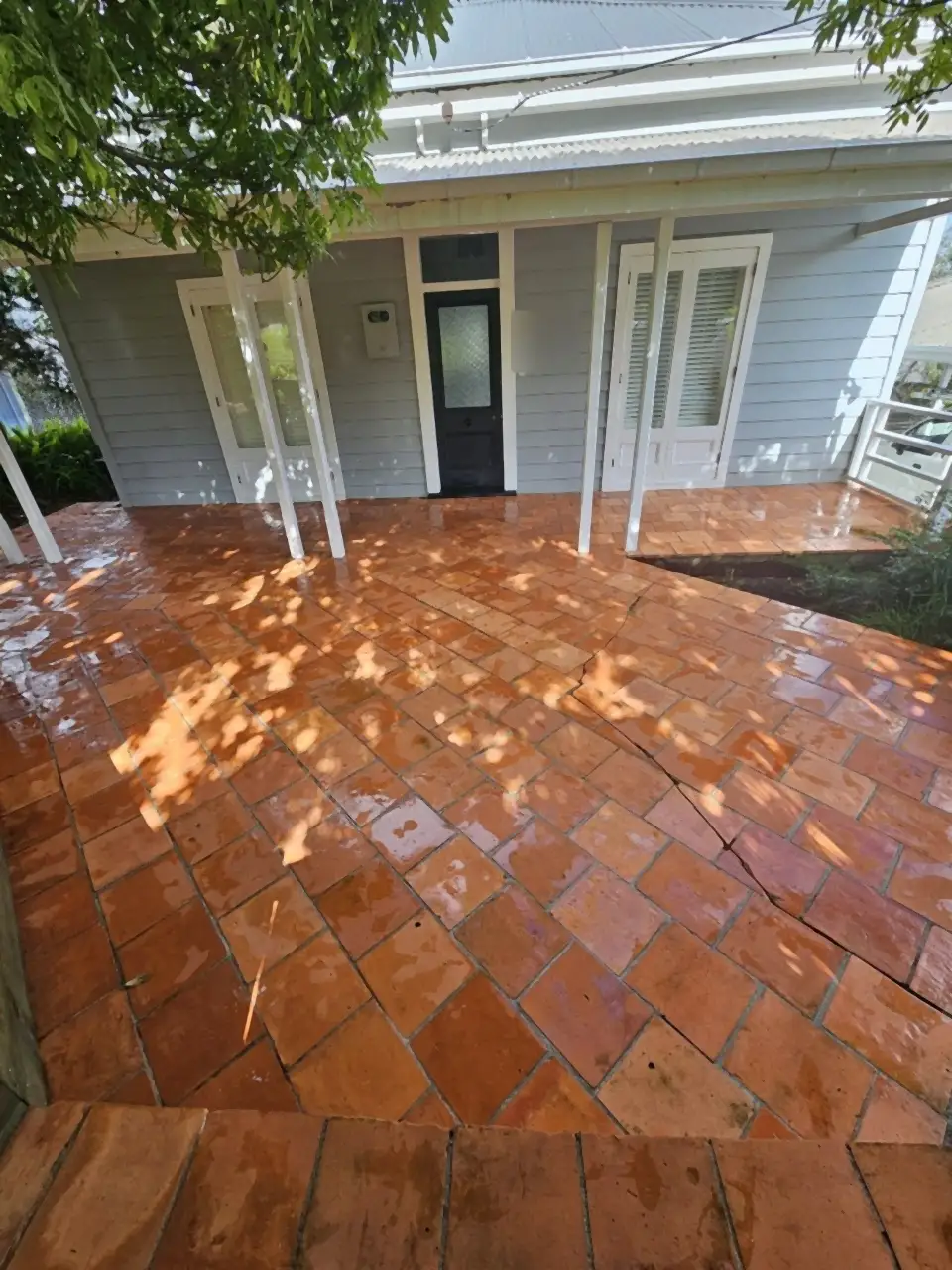 After: The same patio washed back to a deep terracotta